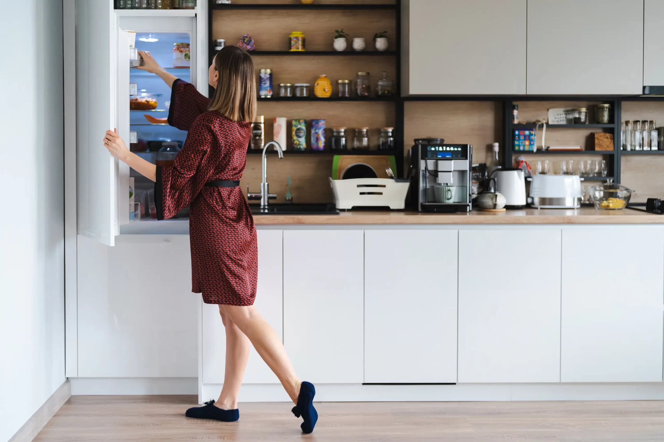 hungry woman looking food fridge home dont have much there white kitchen furniture home wear red silk robe scaled Home Solution India